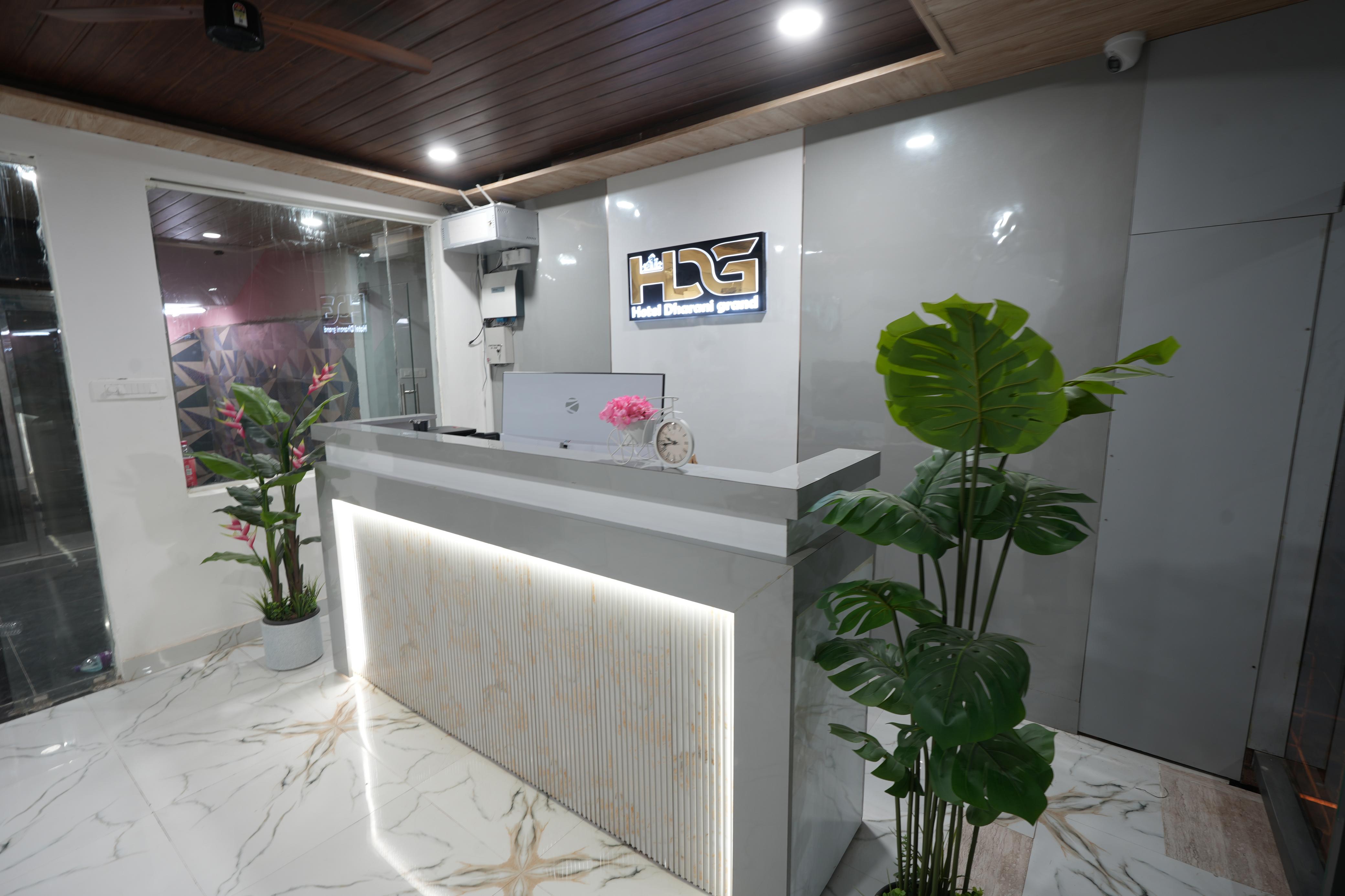 Hotel Dharani Grand reception desk with branded signage