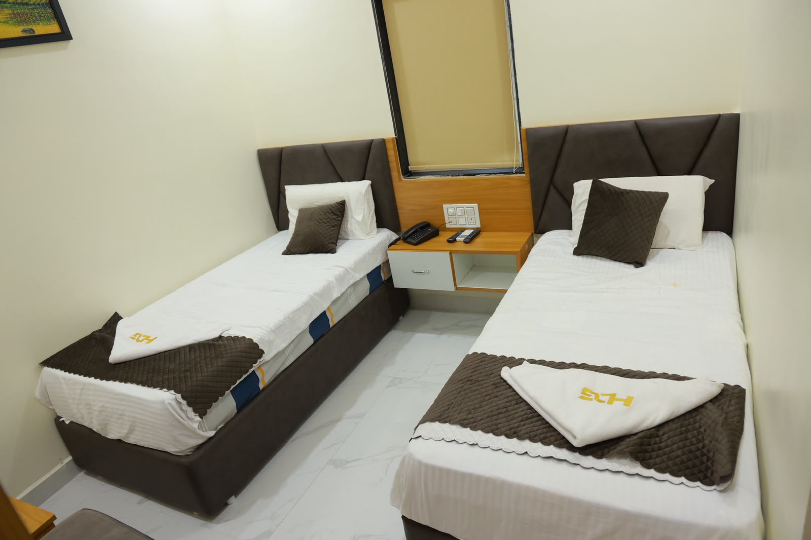 Twin bed guest room at Hotel Dharani Grand Khammam