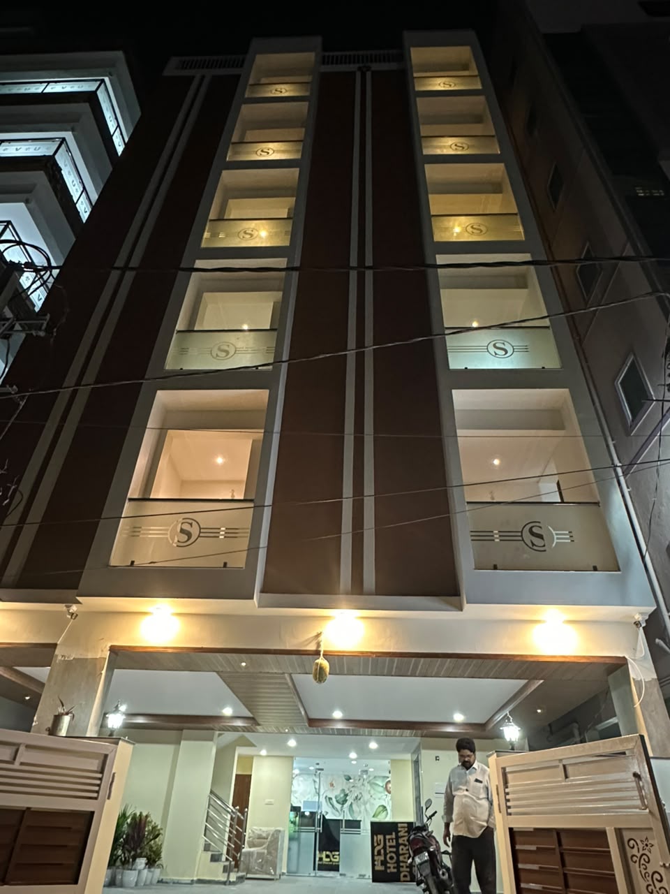Hotel Dharani Grand KPHB building illuminated at night